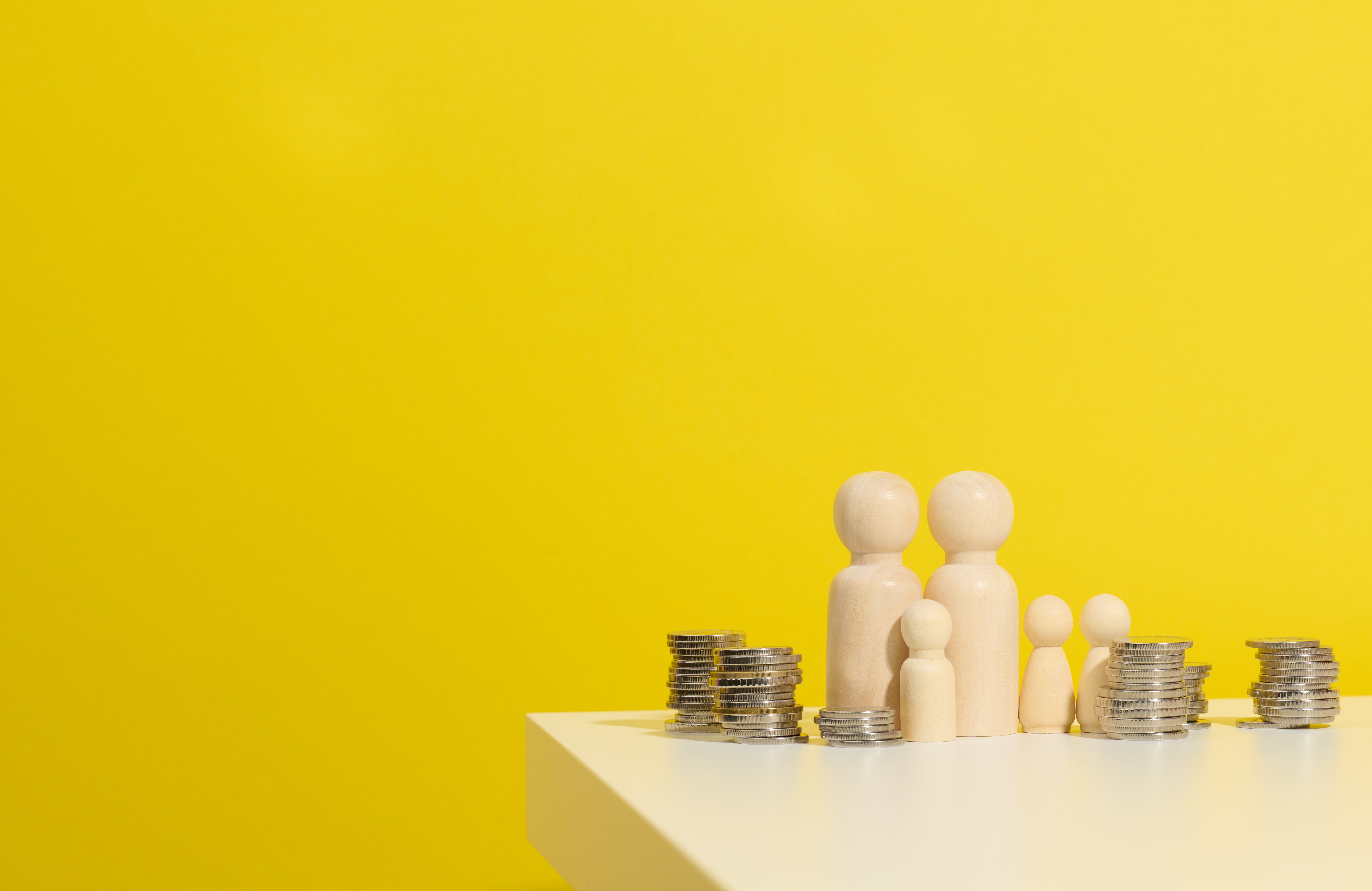 stack-of-metal-coins-and-wooden-figures-of-men-on-2025-03-24-02-00-34-utc-min
