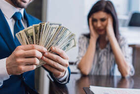 selective-focus-of-collector-with-money-near-stres-2024-11-09-23-12-16-utc