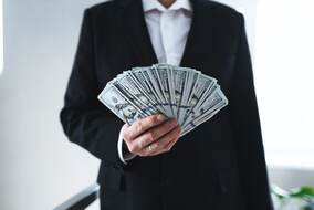 one-hundred-dollar-bills-money-fun-in-hand-of-man-2025-03-07-13-00-36-utc-min